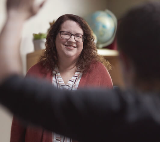 Woman smiling about managing her RA symptoms Woman Smiling
