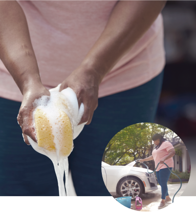 Woman Squeezing a Sponge to Wash a Car