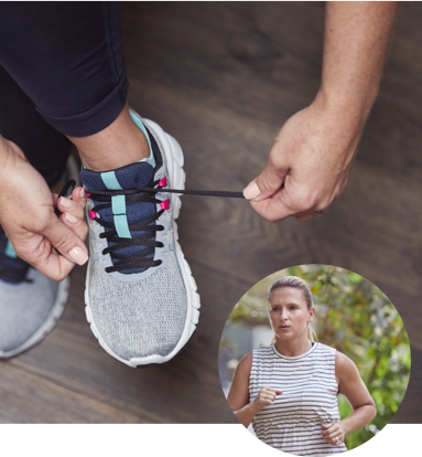 Woman tying her shoes to prepare for a jog Woman Tying Shoes to go on a run