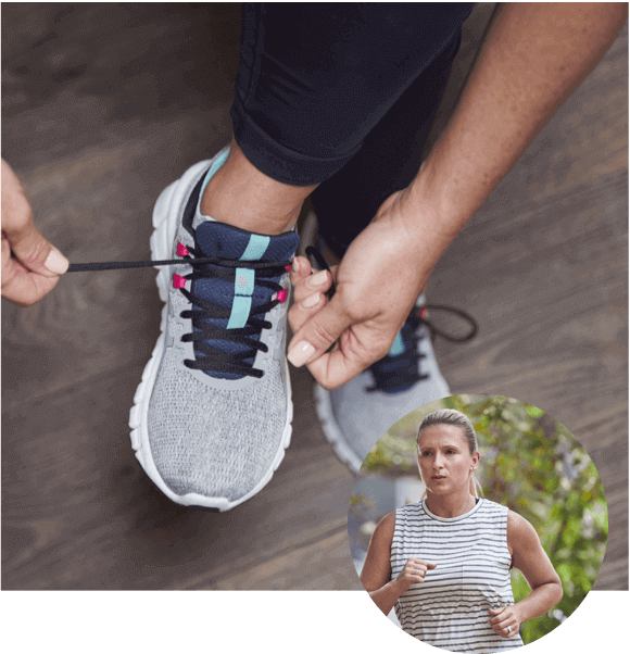 Woman tying her shoes to prepare for a jog Woman Tying Shoes to go on a run